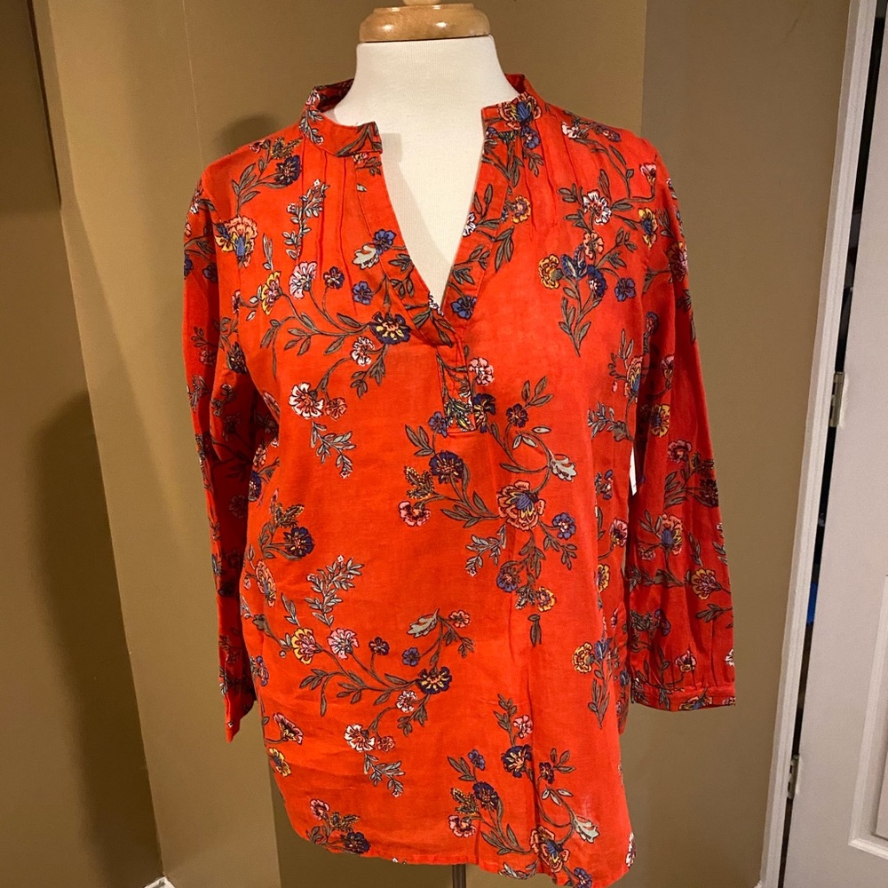 Orange floral long sleeve top.